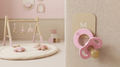 Magnetot pastel pink magnetic pacifier on a tile in a nursery